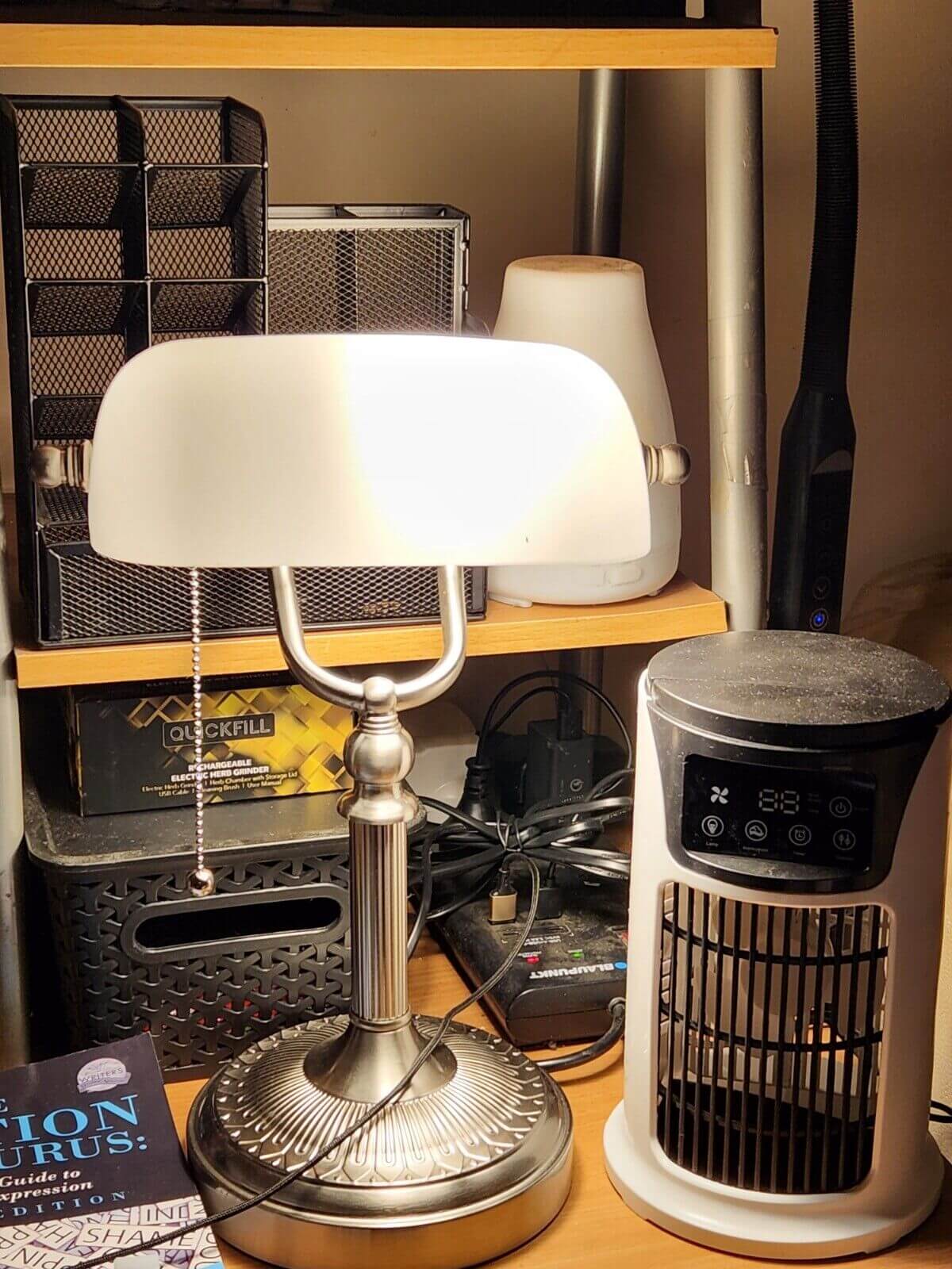 Matted White Glass Banker Lamp ,Sand Nickel Base on a desk with various items in the background.