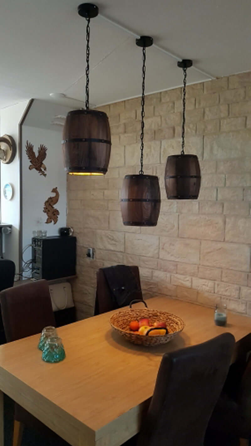 Wood Wine Barrel Pendant Lamp Hanging Unique Kitchen Bar Light Fixtures above a dining table with a fruit basket.