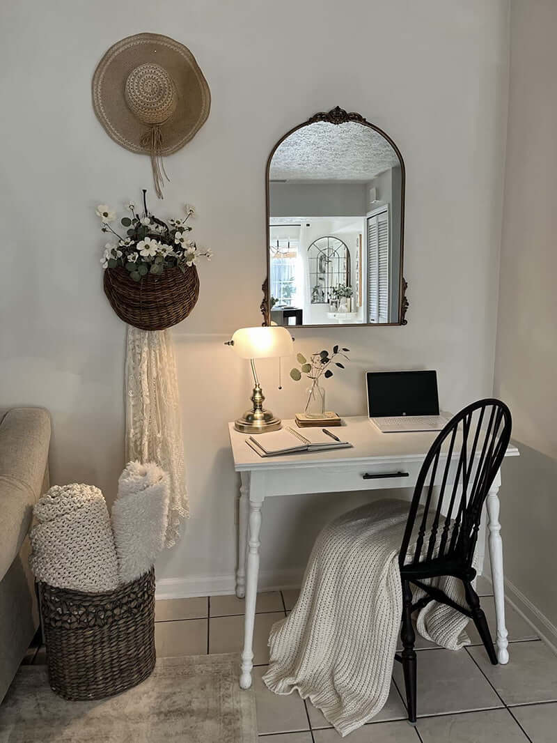 Cozy workspace featuring a White Matted Glass Banker Lamp, desk, woven chair, and decorative elements.