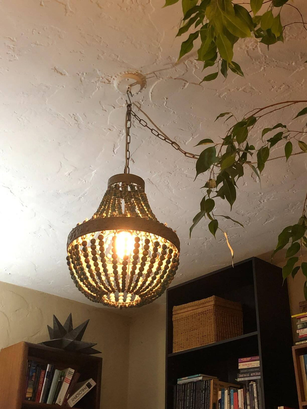 Wood Bead Chandelier Pendant antique Blue Finishing,Plug in, hanging from the ceiling with light on.