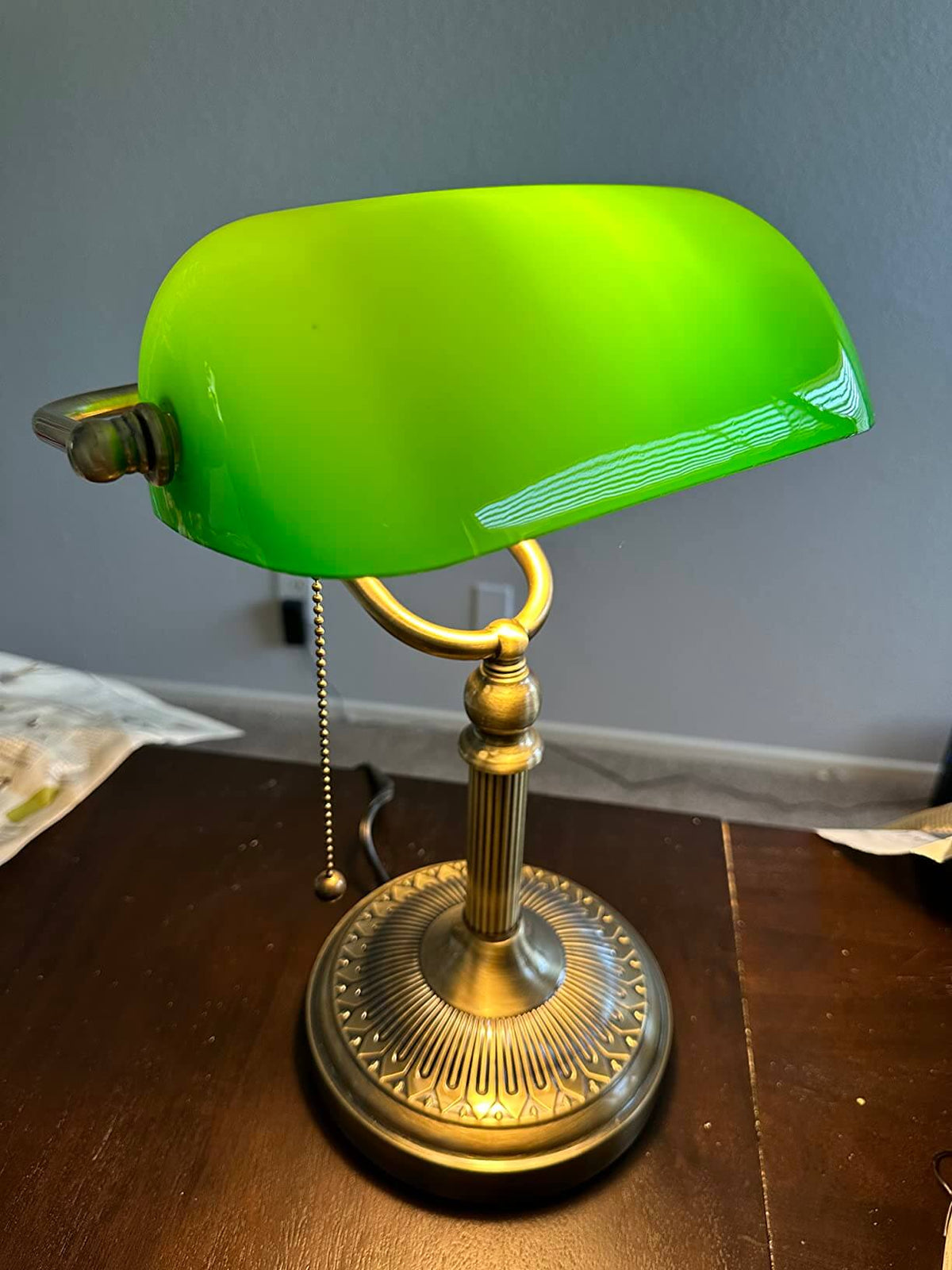 Newrays Green Glass Banker Lamp with a vibrant green shade, adjustable design, and elegant bronze base.