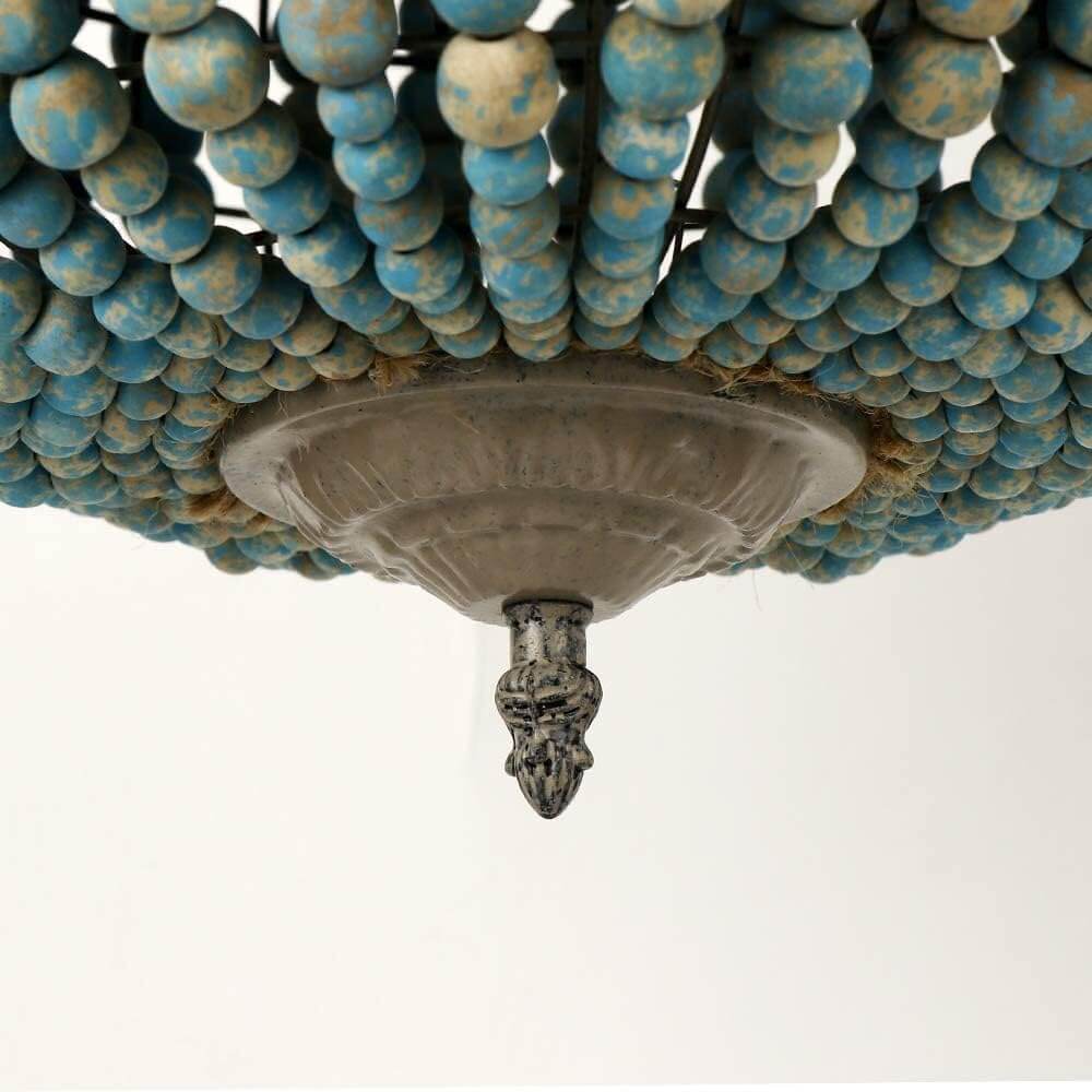 Close-up view of the Blue Wood Bead Globe Pendant Light showcasing intricate design and texture.
