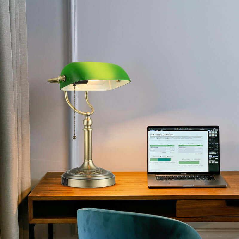 Green Glass Banker Lamp,USB Fast Charging Port on a wooden desk with a laptop.