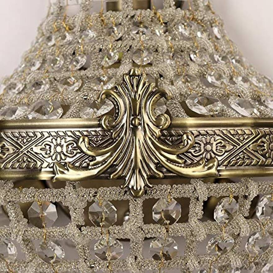 Close-up of vintage royal empire crystal wall sconces showcasing intricate metalwork and shimmering crystal accents.