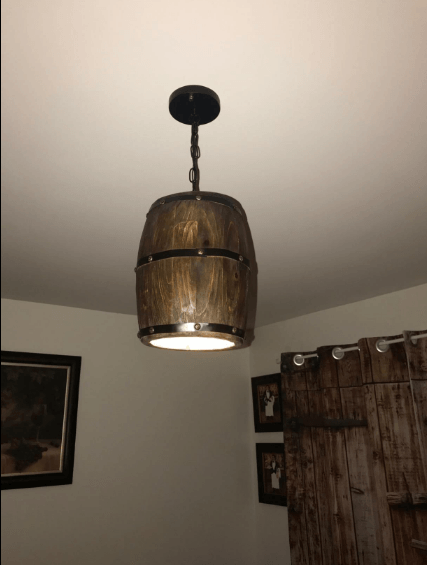 Wood Wine Barrel Pendant Lamp Unique Kitchen Bar Light H30 hanging from the ceiling, illuminating a rustic interior.
