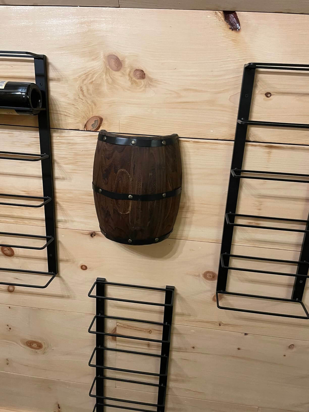 Wood Wine Barrel Wall Sconce,Hard Wired,2 Pack displayed on a wooden wall with black metal wine racks.