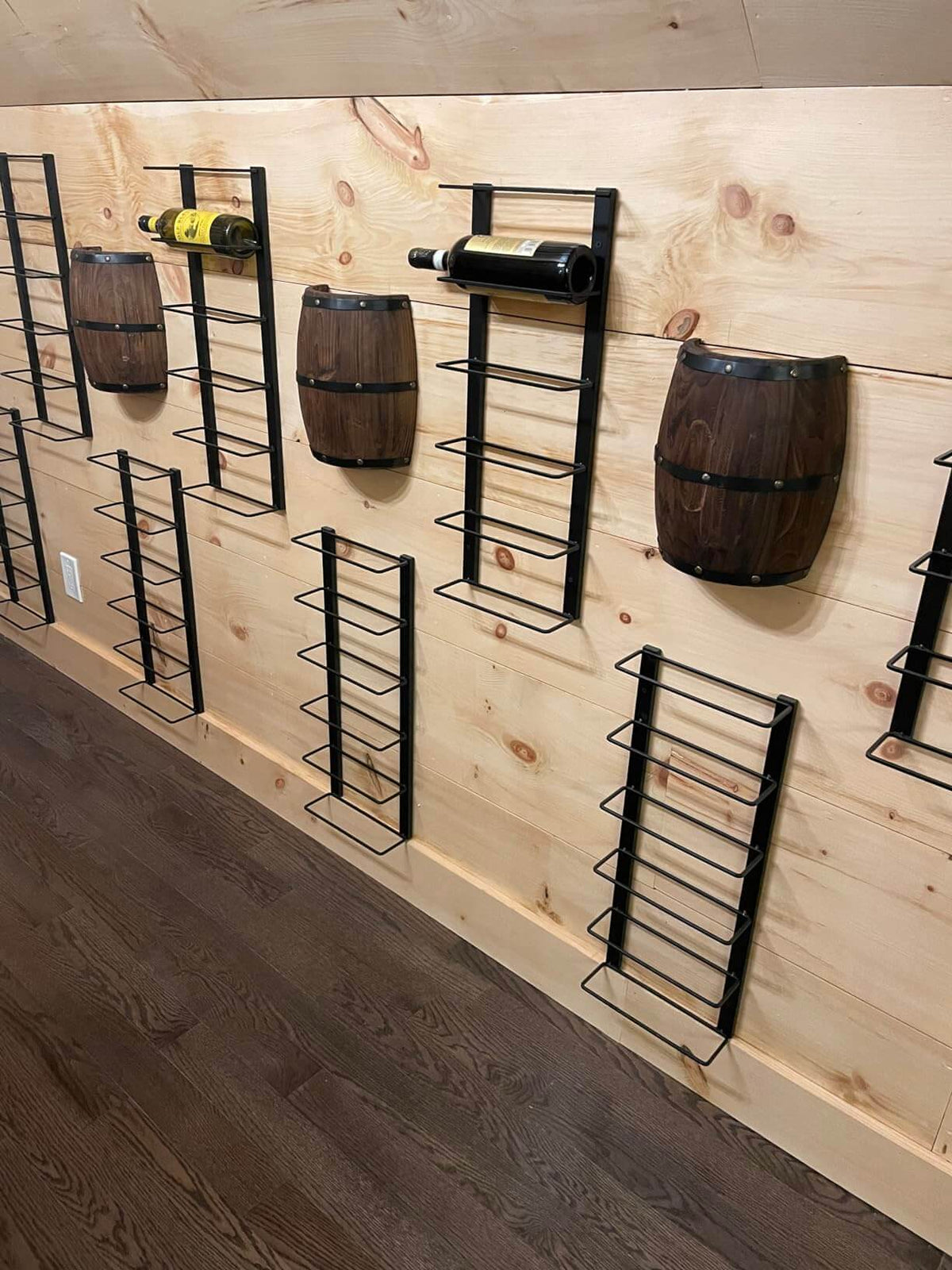 Wood Wine Barrel Wall Sconce,Hard Wired,2 Pack displayed on a wooden wall with wine bottles and metal racks.