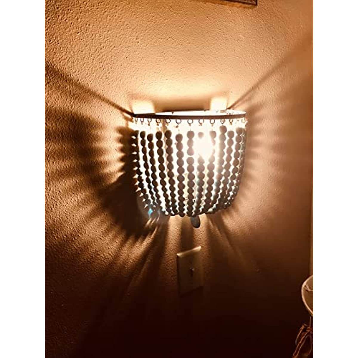 2 Pack Wood Bead Wall Lamp,Hard Wired,E12/E14 Socke mounted on wall, emitting light, showcasing beads and shadows.
