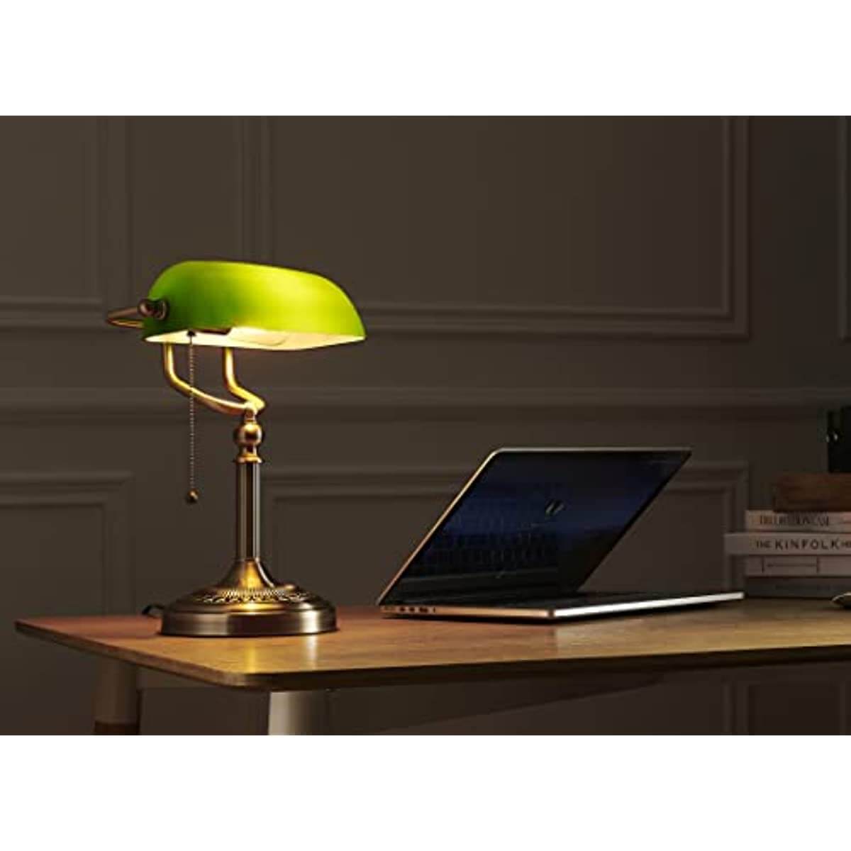 Newrays Green Glass Banker Lamp illuminating a desk with a laptop in a stylish home office setting.