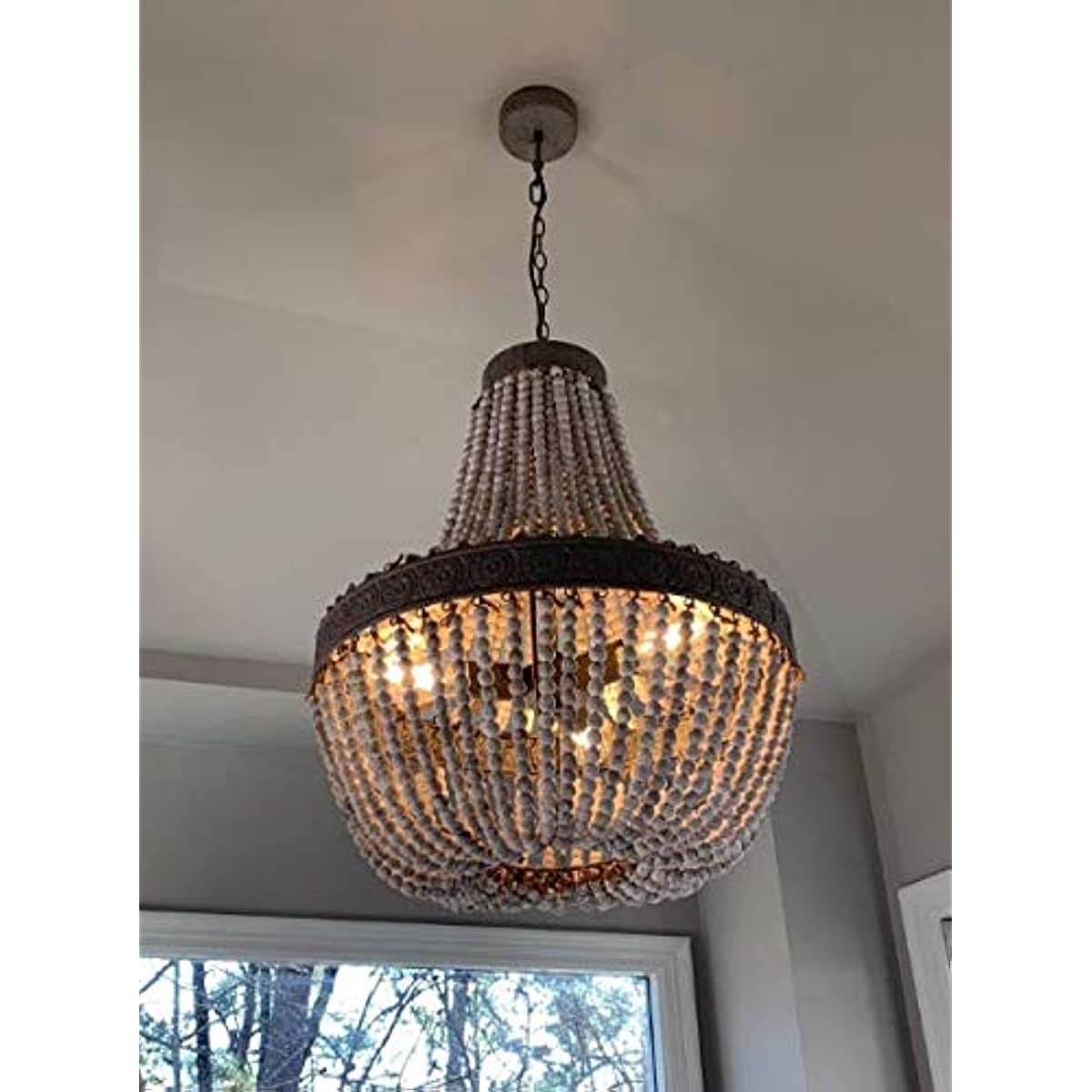 Newrays Wood Beaded Chandelier Pendant Three Lights hanging in a room with three light bulbs visible.