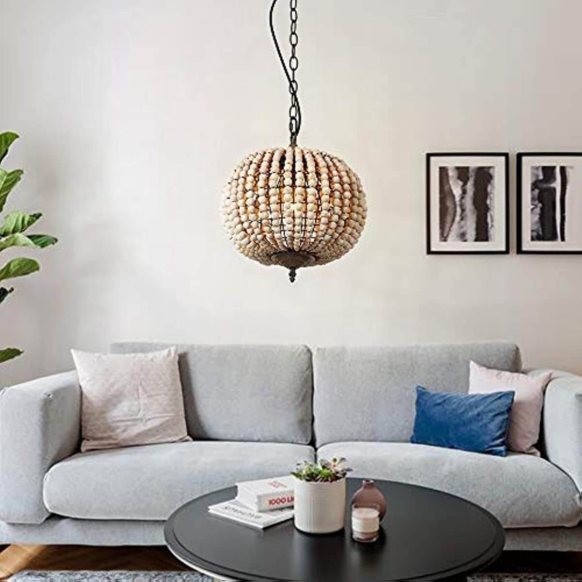 Globe Wood Bead Chandelier Pendant Gray White Finishing hanging above a modern gray sofa in a stylish living room.