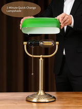 Person demonstrating the Newrays 1-Minute Quick-Change Shade Classic Green Glass Bankers Desk Lamp