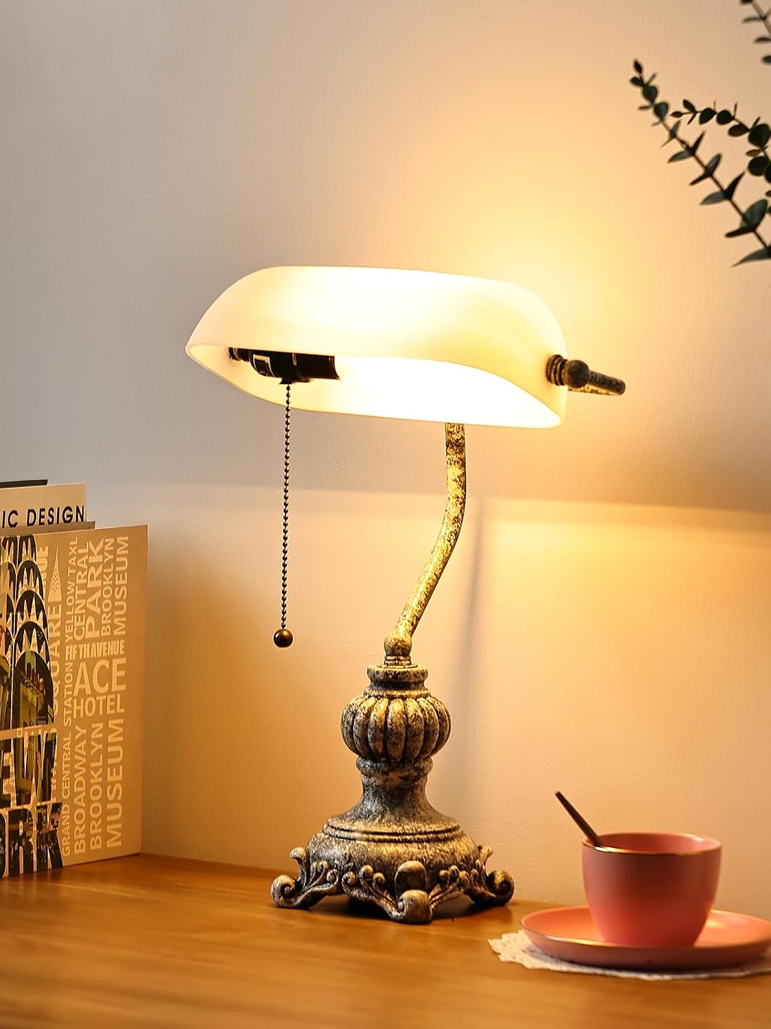 Newrays retro glass bankers desk lamp with elegant design and warm light on a wooden desk.