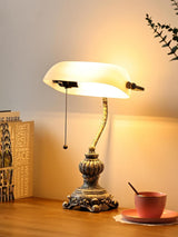 Newrays retro glass bankers desk lamp with elegant design and warm light on a wooden desk.