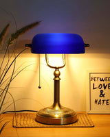 Newrays Blue Glass Bankers Desk Lamp with brass base and blue glass shade, enhancing home decor.