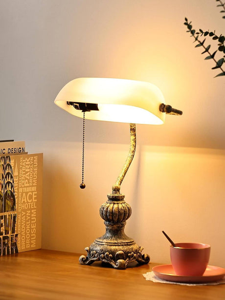 Newrays retro glass bankers desk lamp with elegant design and warm light on a wooden desk.