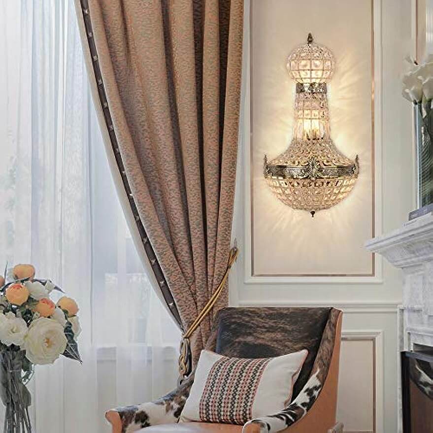 vintage royal empire crystal wall sconces illuminating a stylish living room with elegant decor.