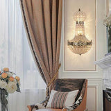 vintage royal empire crystal wall sconces illuminating a stylish living room with elegant decor.