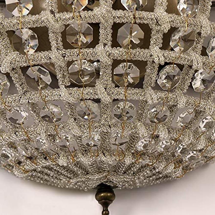 Close-up view of vintage royal empire crystal wall sconces showcasing intricate metalwork and sparkling crystal accents.
