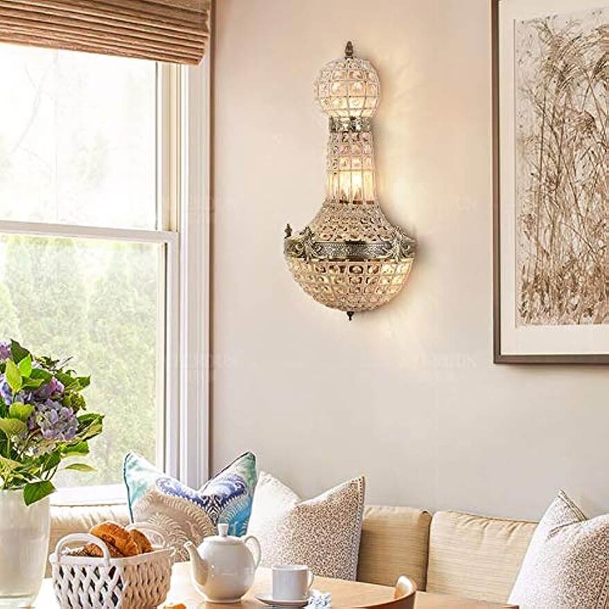 Vintage royal empire crystal wall sconces illuminating a cozy living space with elegant design and intricate details.
